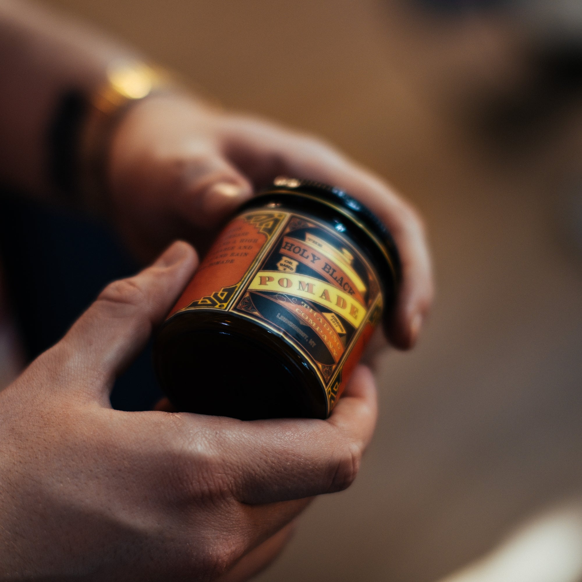 The Holy Black Secret Stash Grease Pomade — men's grooming product — in use