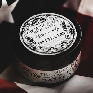 The Holy Black Matte Clay Hair Pomade jar detail — ornate label