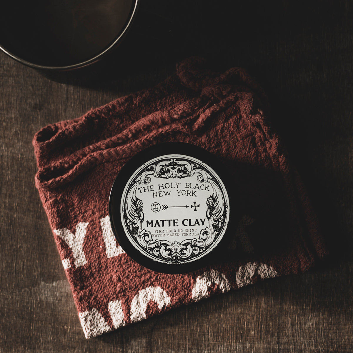 The Holy Black Matte Clay Hair Pomade product flat lay