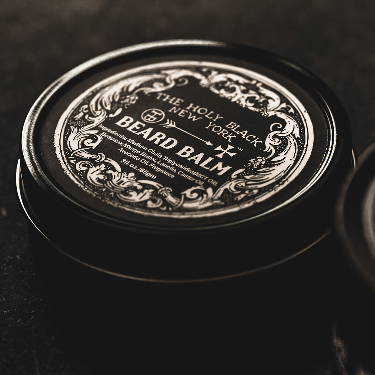 The Holy Black Beard Balm jar open — beeswax and butter beard styling balm