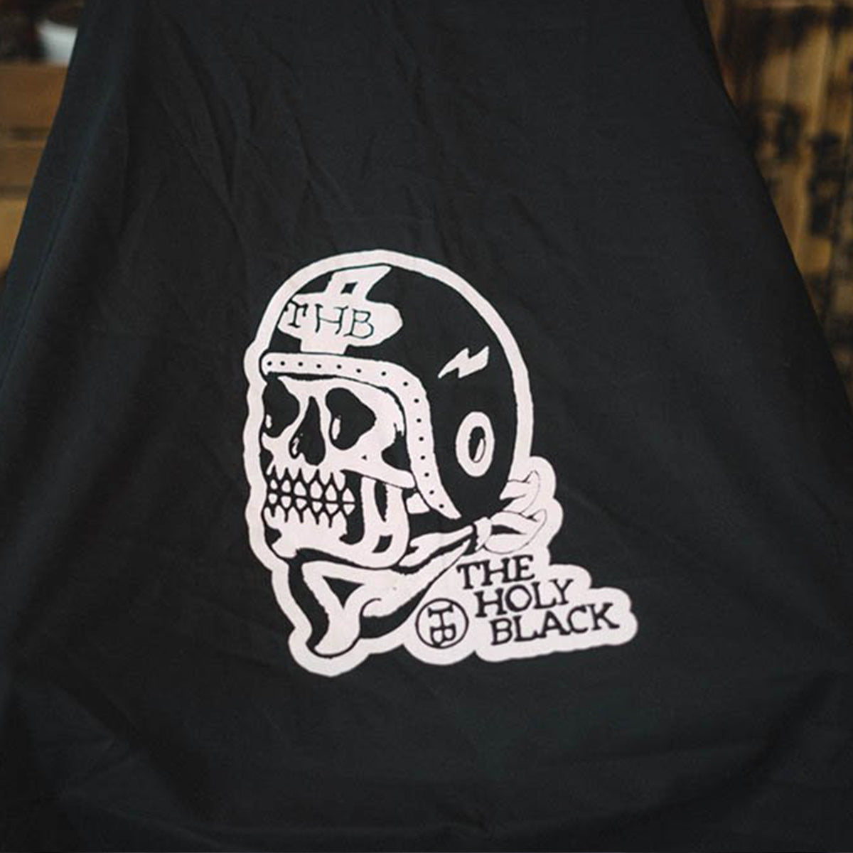 The Holy Black Barber Capes — men's grooming product — in use